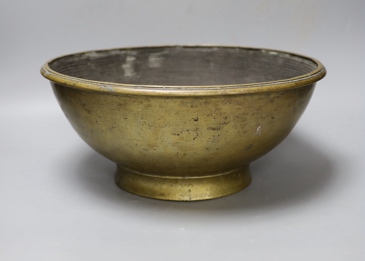 A Himalayan bronze ritual vessel, possibly Tibetan, inscribed 1916 to the interior , 36cms diameter.
